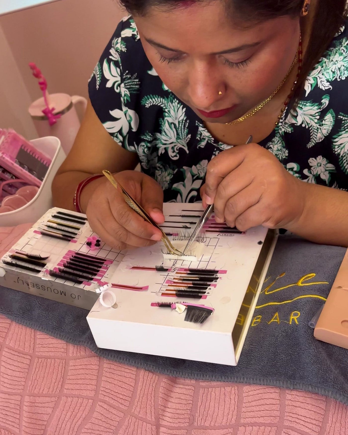 Student practicing lash pickup and placement on a lash tile