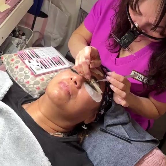 Lexie trainer working on a live model with a lash tile beside her